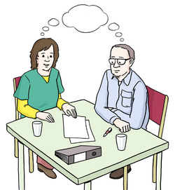 Das Bild zeigt zwei Menschen an einem Tisch