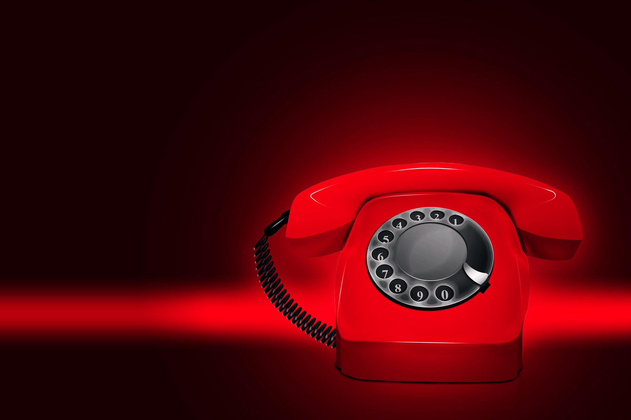 Das Bild zeigt ein rotes Telefon