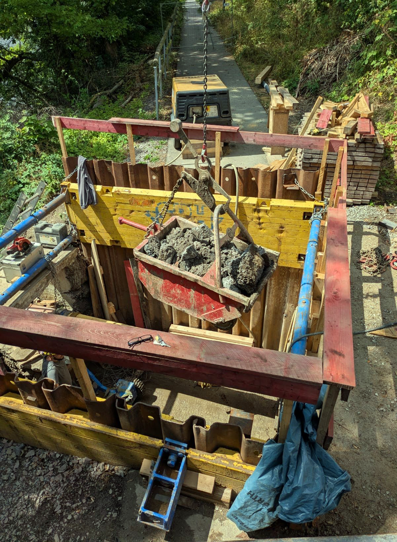 Der anfallende Boden und Betonbruch wird über denselben Weg, auf dem später auch neue Bauteile eingebracht werden, abtransportiert.